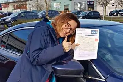 women standing at the car after passing the driving test in Cork