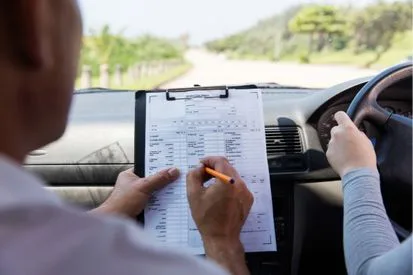 A woman doing a moch driving test with an instructor